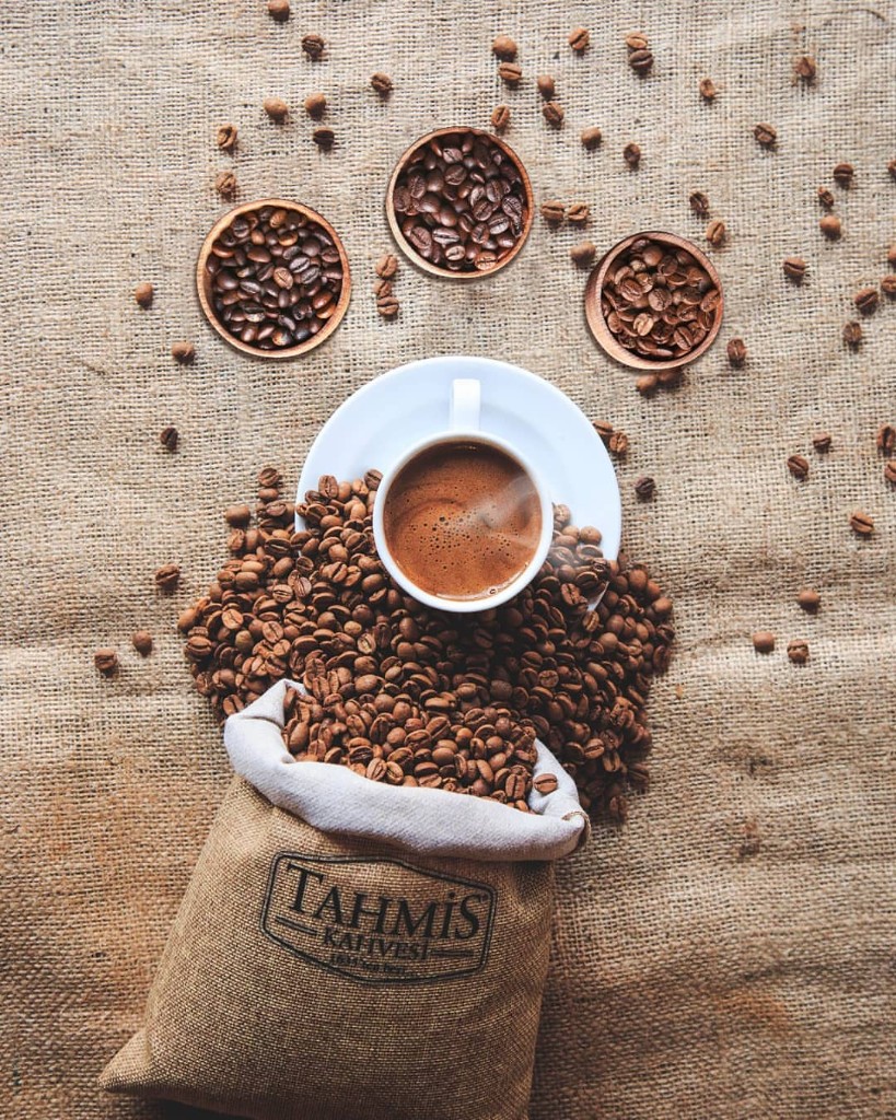 Three wooden bowls of differently roasted Tahmis coffee beans